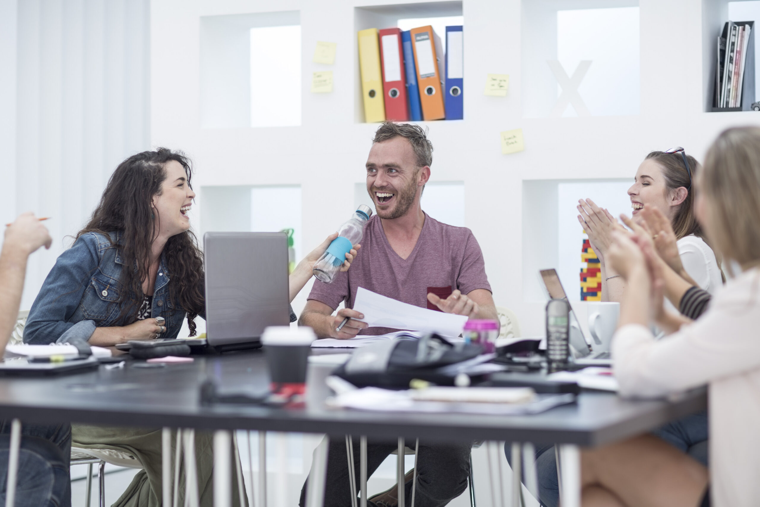 A team with healthy work habit applauding their colleague.